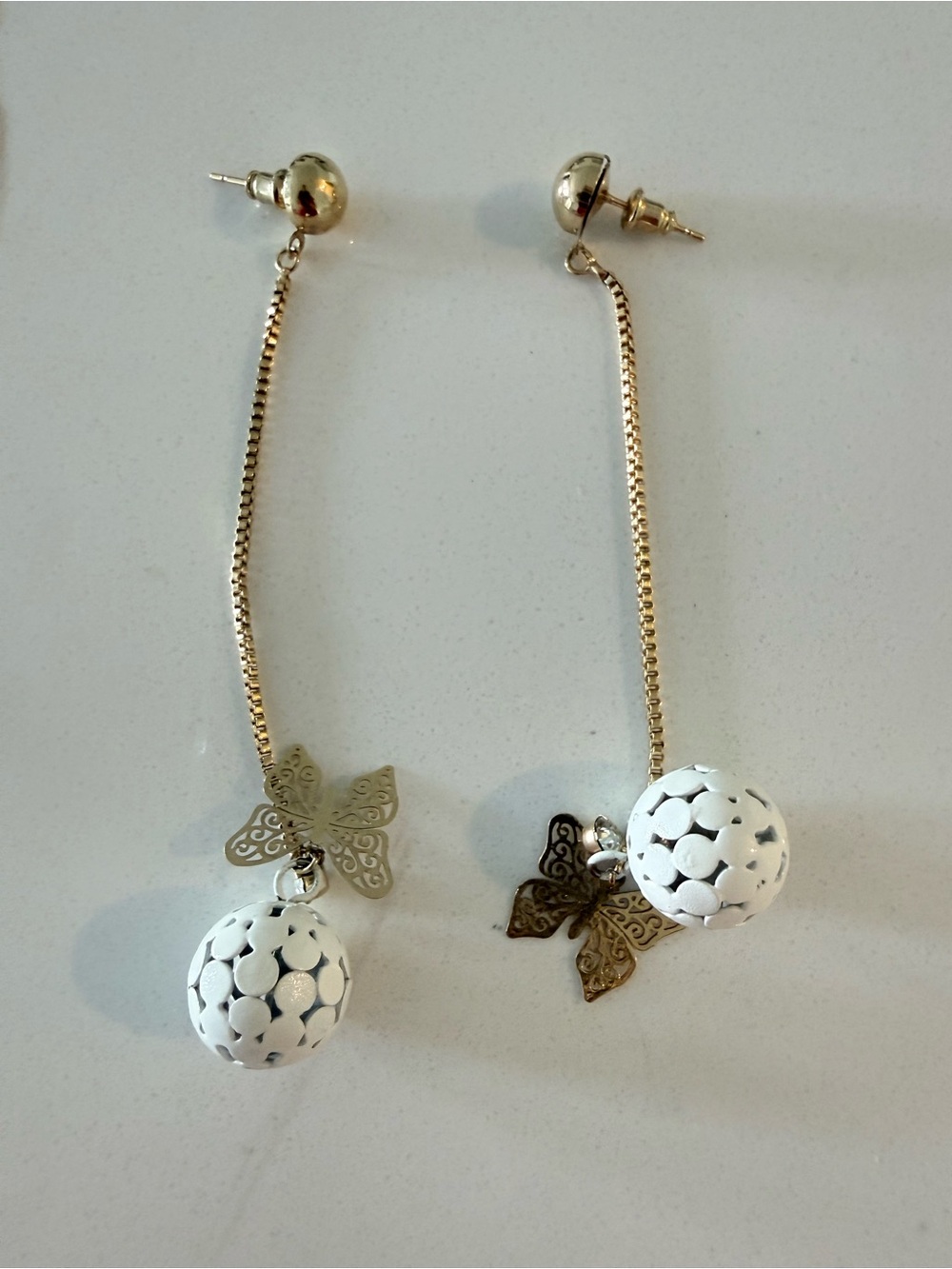 Elegant Gold tone Drop Earrings with White Filigree Beads and Butterfly Accent